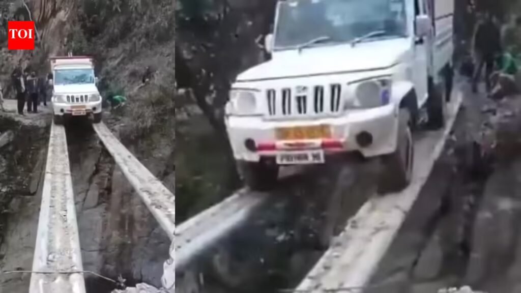 Mahindra Bolero Pik-up balances on pipe to cross deep ditch, video goes viral Mahindra Bolero Pik-up balances on pipe to cross deep ditch, video goes viral
